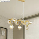 Modern gold pendant light with clear cognac glass for dining room