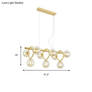 Modern gold pendant light with clear cognac glass for dining room