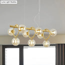 Modern gold pendant light with clear cognac glass for dining room