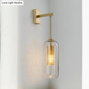 Modern gold perforated sconce with clear glass bedroom wall light