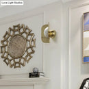 Modern gold sconce light with curved metal shade bedroom lamp