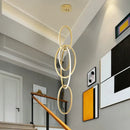 Modern gold steel pendant light interlocking rings dining room
