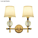 Modern gold wall light with crystal and fabric shade bedroom