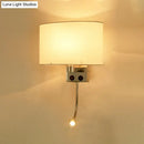 Modern gold wall sconce with fabric shade and bedroom reading light