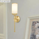 Modern gold wall sconce with milky glass shade for living room