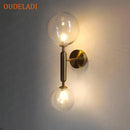 Modern golden led wall sconce with milky glass globes for bedroom