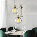 Modern gray glass ball pendant lights – dining room brass accents