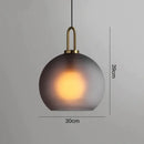 Modern gray glass ball pendant lights – dining room brass accents