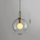Modern gray glass ball pendant lights – dining room brass accents