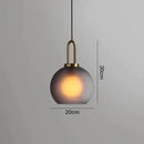 Modern gray glass ball pendant lights – dining room brass accents