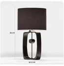 Modern matte black metal table lamp with fabric shade for living room