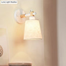 Modern nordic wood wall lamp with horn shade – bedroom sconce