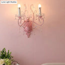 Modern pink metallic scroll arm wall lamp with crystal bedroom sconce