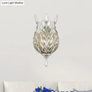 Modern silver & brass laurel wall light with crystal drop bedroom