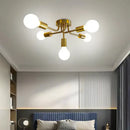 Modern symmetrical brass ceiling light with five spheres for living room