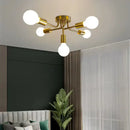 Modern symmetrical brass ceiling light with five spheres for living room