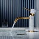 Modern white marble and brushed gold bathroom faucet with swivel spout