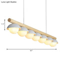 Modern wood stem linear chandelier with white shade dining room light