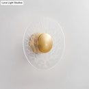Modernist brass and clear glass wall light fixture living room