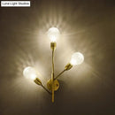 Modernist brass wall mount light fixture with prismatic glass bedroom