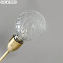 Modernist brass wall mount light fixture with prismatic glass bedroom