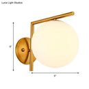 Modernist gold and white globe sconce light – bedroom wall lamp