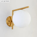 Modernist gold and white globe sconce light – bedroom wall lamp