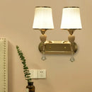 Modernist gold crystal wall sconce with pleated shades living room