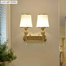 Modernist gold crystal wall sconce with pleated shades living room