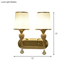 Modernist gold crystal wall sconce with pleated shades living room