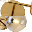 Modernist gold wall lamp with glass shade for living room