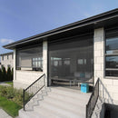 Modern house exterior with large glass doors and windows.