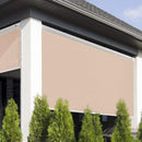 Beige exterior roller shutter on a building with green trees in the foreground