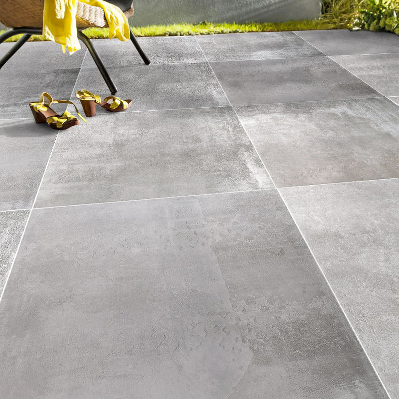 Nexos gray porcelain outdoor pavers 2cm thick installed outdoors patio yellow shoes