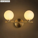 Nordic brass wall sconce light with glass globe – bedroom lighting