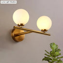 Nordic brass wall sconce light with glass globe – bedroom lighting