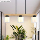 Nordic wooden linear pendant with glass shades for dining room