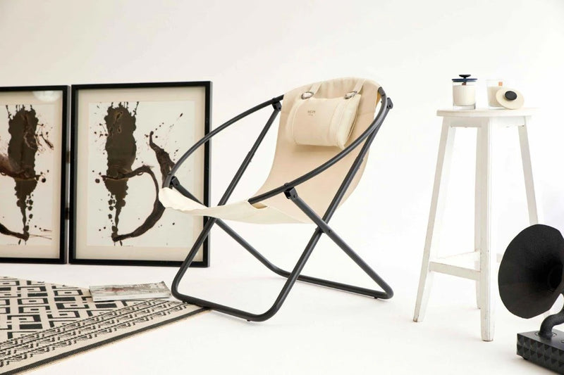 off white foldable metal frame faux leather chair black frame product shot angle view