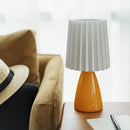 Orange ceramic milkshake bedside lamp with pleated shade for bedroom