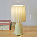 Orange ceramic milkshake bedside lamp with pleated shade for bedroom