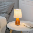 Orange ceramic milkshake bedside lamp with pleated shade for bedroom