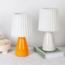 Orange ceramic milkshake bedside lamp with pleated shade for bedroom