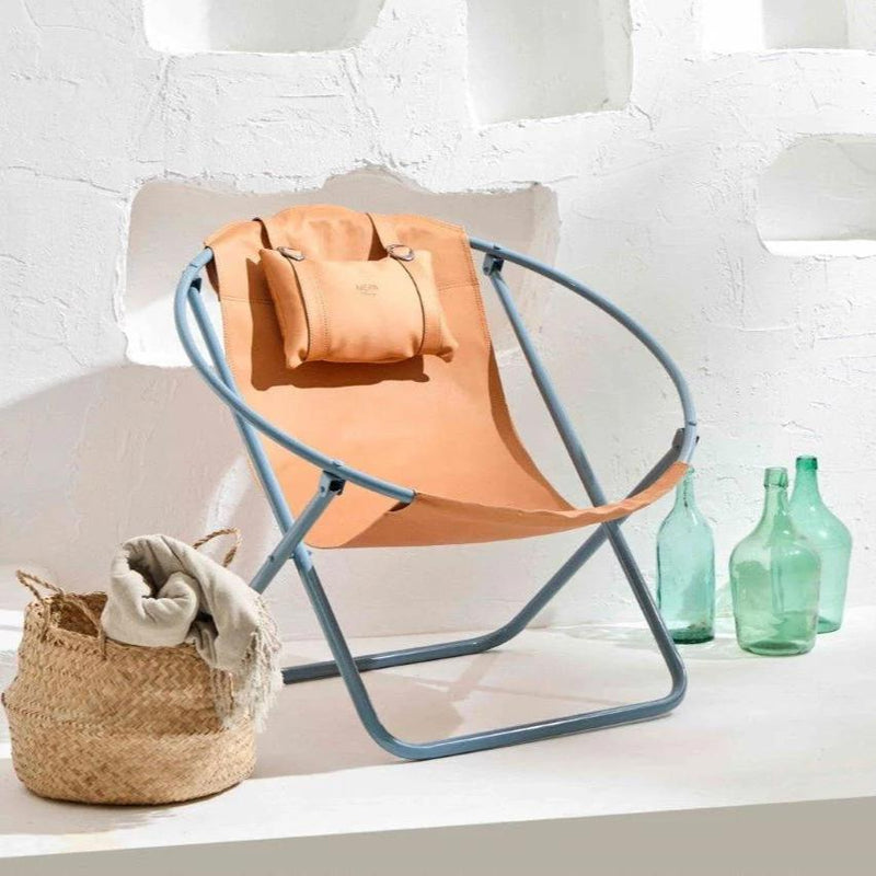 orange foldable metal frame faux leather chair product shot green empty bottles and bamboo towel basket