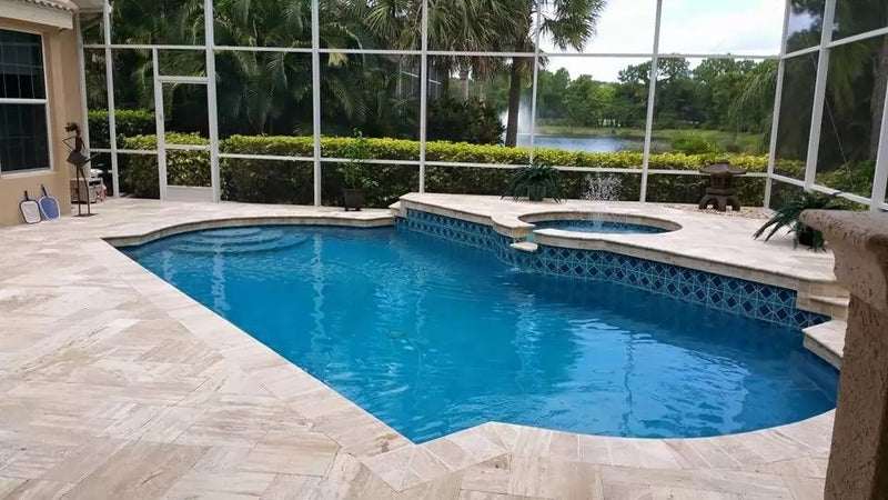 patara beige vein-cut travertine pavers tumbled pattern installed around pool wide view