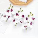 Pink and white artificial flower stems for wedding garden arch decor