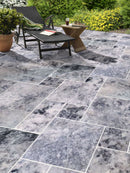 Platinum Silver Marble Pattern Tumbled Pavers - Full Truckload patio sun bed side table and plant wide view