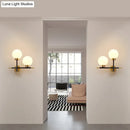 Post-modern white and brass sphere wall sconce bedroom light