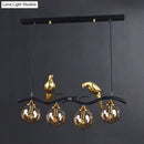 DecorBites™ Postmodern Iron Pendant Light with 4-Lights, Black/Gold Finish, Amber Ball Glass Shade, Bird Deco - Sprig Island