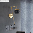 Postmodern black & gold swing arm wall sconce with clear glass bedroom light