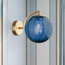 Postmodern brass armed ball sconce – bedroom amber glass wall light